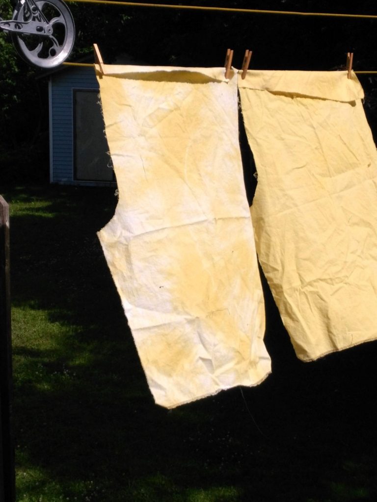 Onion skin dyed fabric hanging to dry clothesline