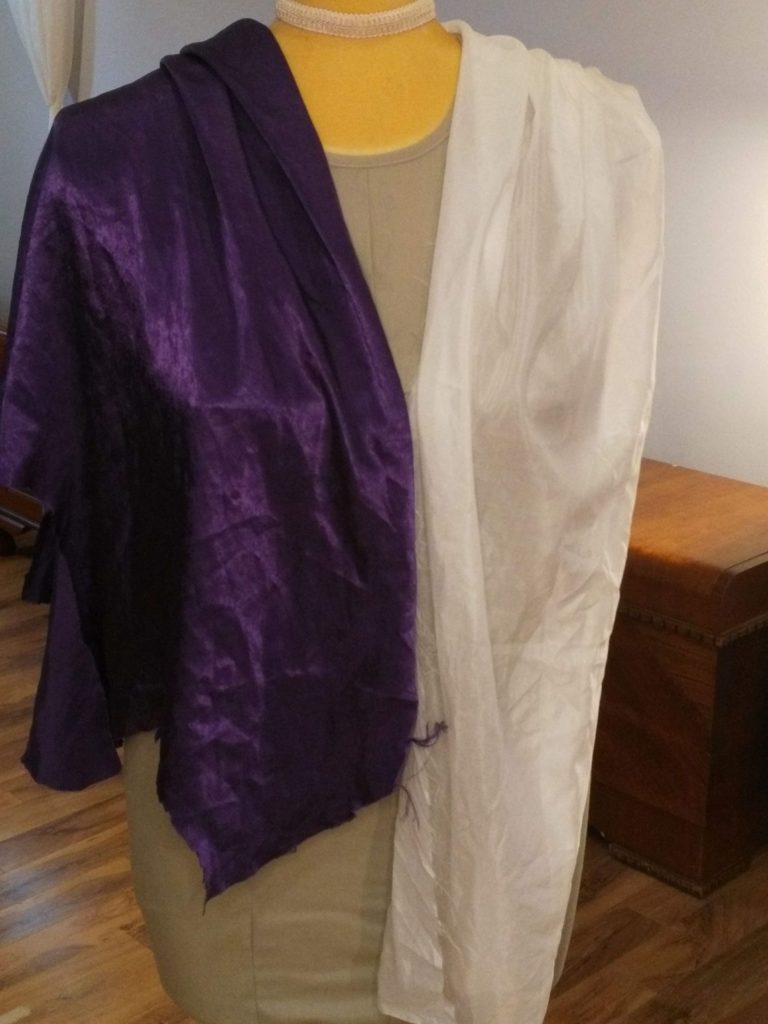 Selecting fabric: Purple satin and sheer white silk draped on a mannequin to compare drape