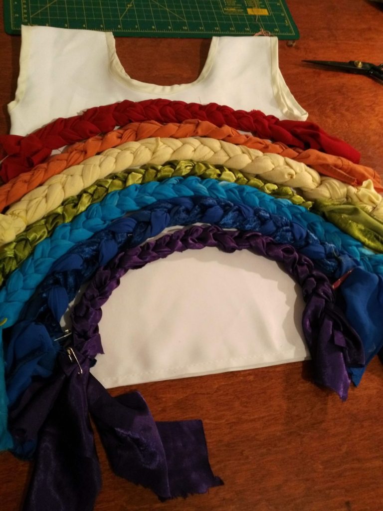 Pin rainbow colours to costume